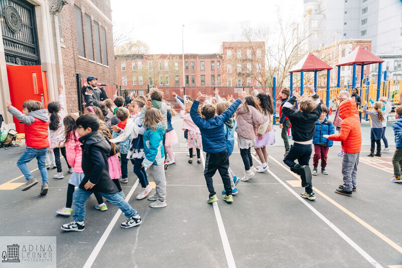 PS118 students dancing in the school yard.