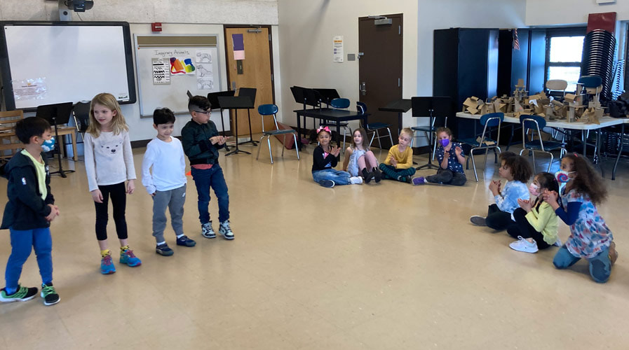 Students learning the dance moves with Mr. Mark.