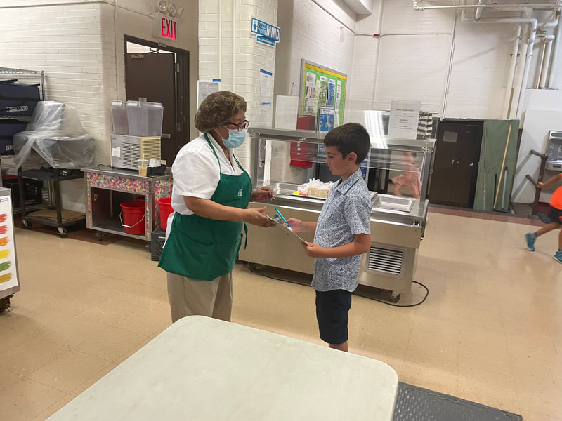 Jonah sharing ideas about the food with our school dietitian Maria.