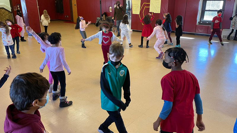 Students dancing with their friends in the gym.
