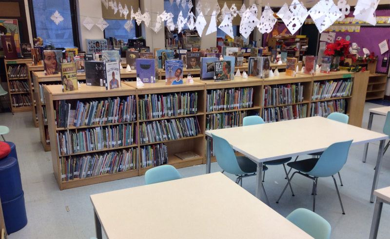 Bookcases with tables at the PS118 library.
