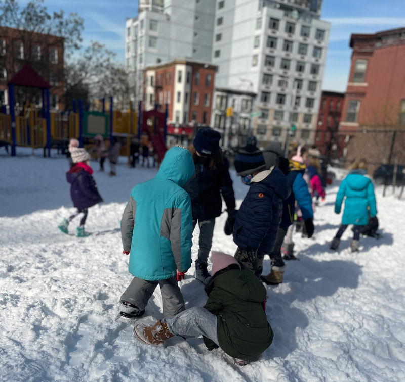 Students had a snow fight in the school yard.