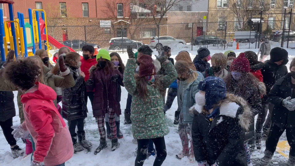 PS118 students posed for a picture in the snowy school backyard.